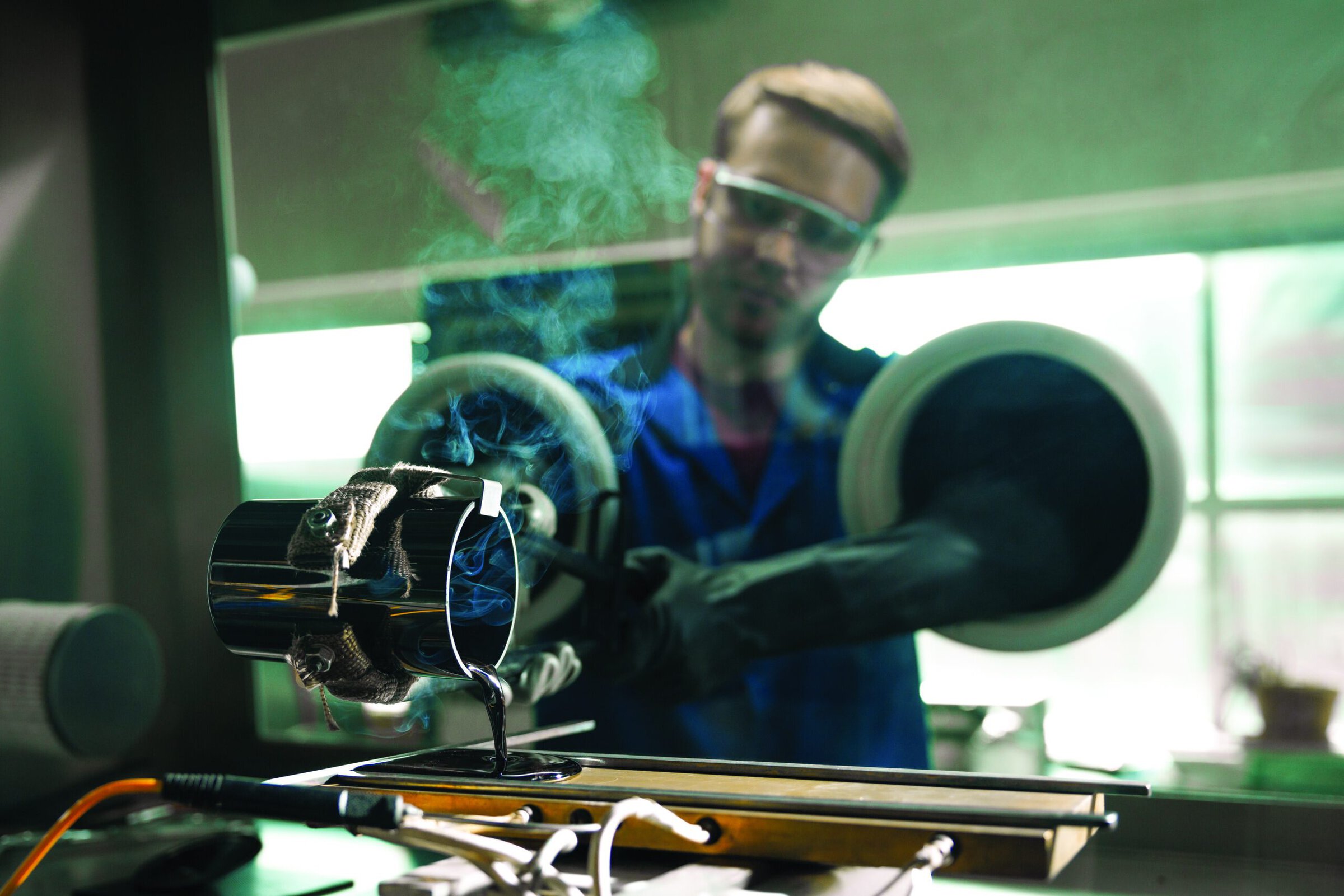 Casting of a ~150 g NaPSON GSE preform on a preheated brass annealing mold to be reheated and drawn into a thin film for use in solid-state batteries. <em>Credit: Ryan Riley, College of Engineering, Iowa State University</em> 