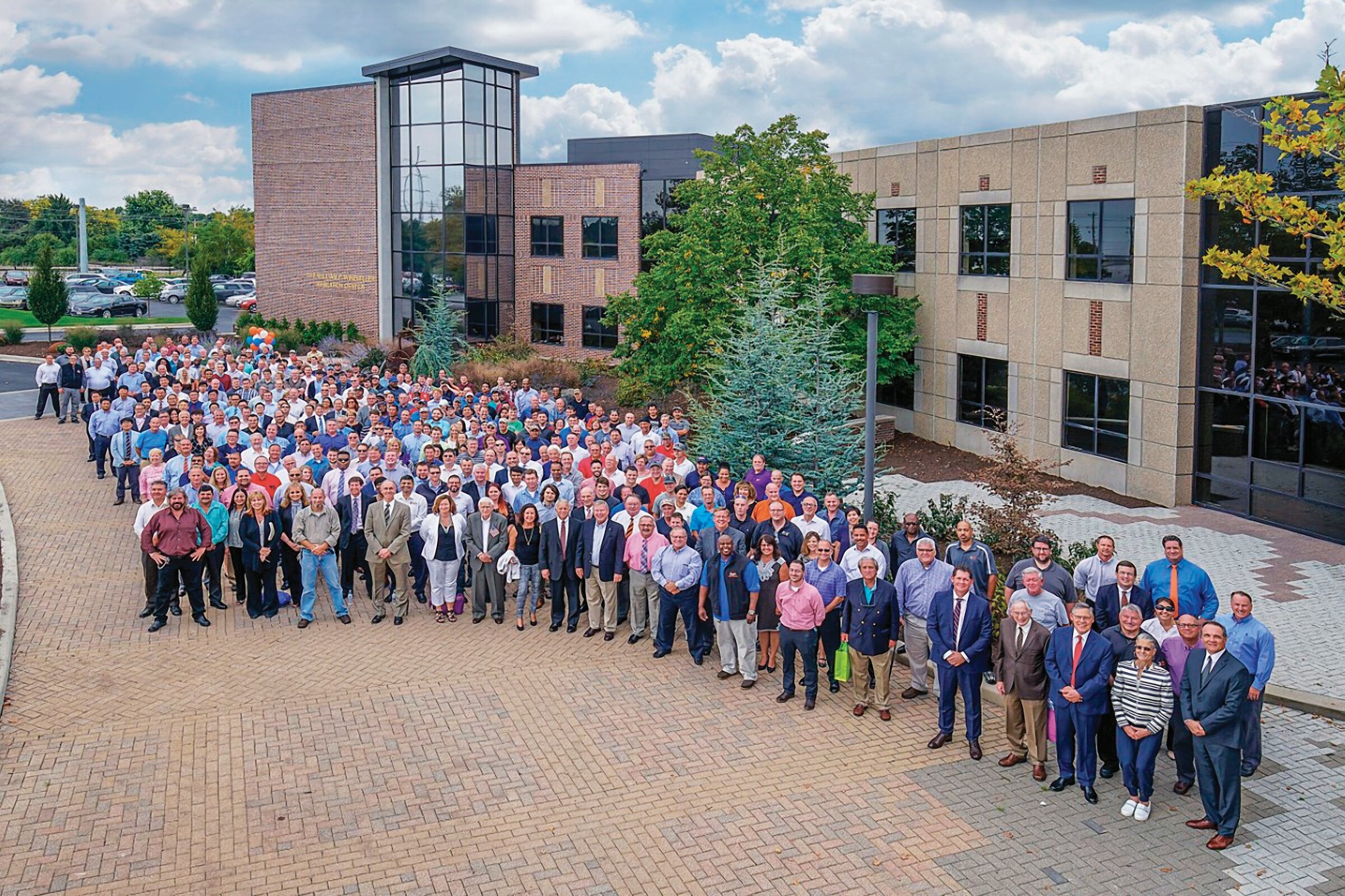 Allied Mineral Products employees gather in a large group in front of their headquarters in Columbus, Ohio.