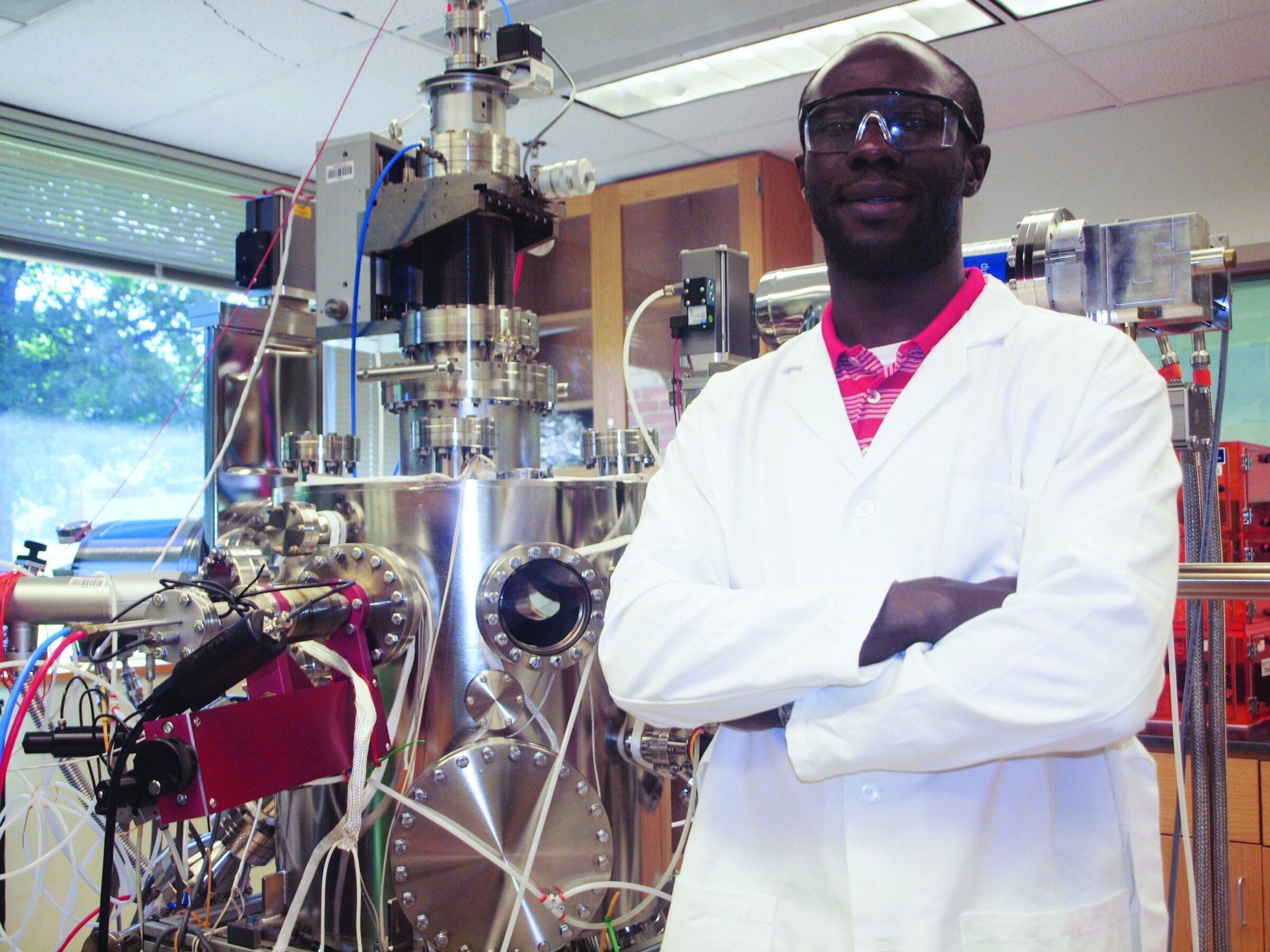Dr. Douglas N. Leonard, a 2018 NSF CAREER award recipient, stands next to advanced ceramics research equipment.
