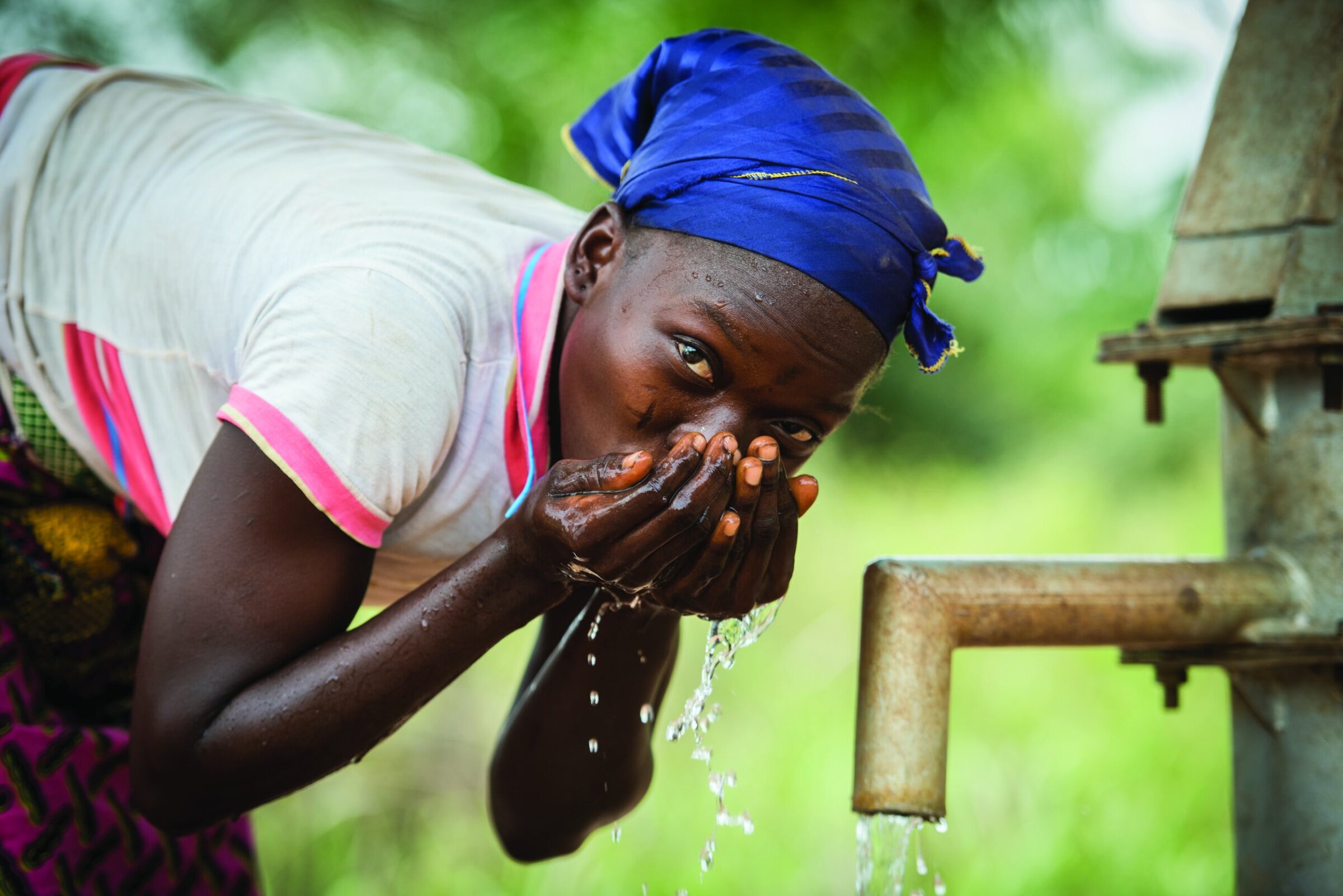 Woman drinking water at a well