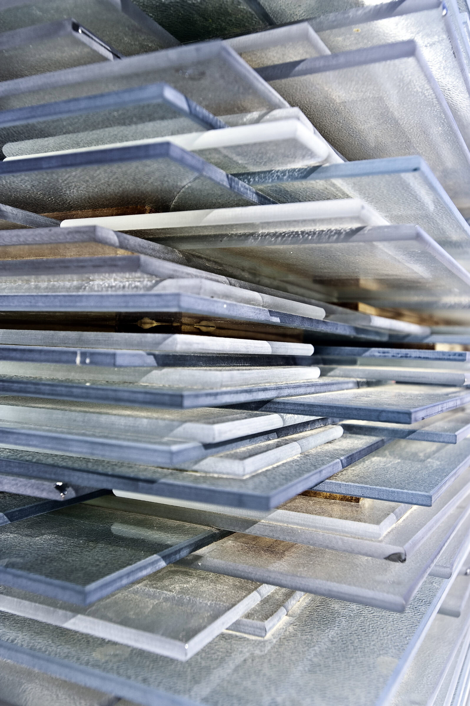 Different glass ceramic tiles stacked in a display at an ceramics industry exhibition.
