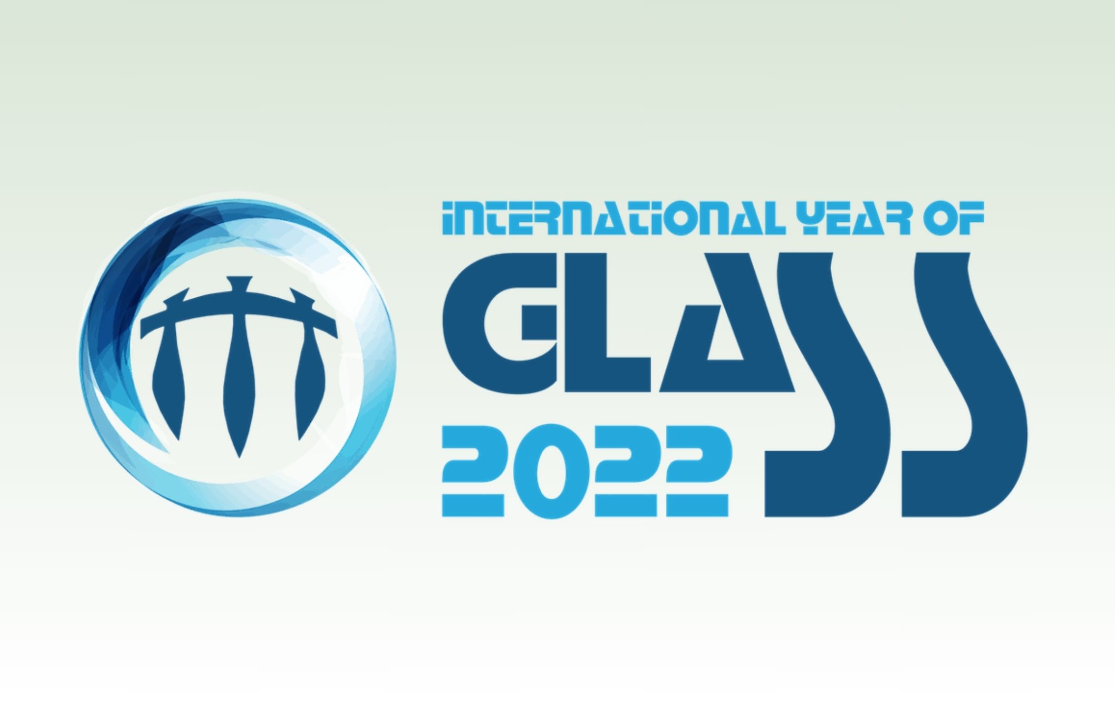 International Year of Glass logo on top of a faded light green to white background.