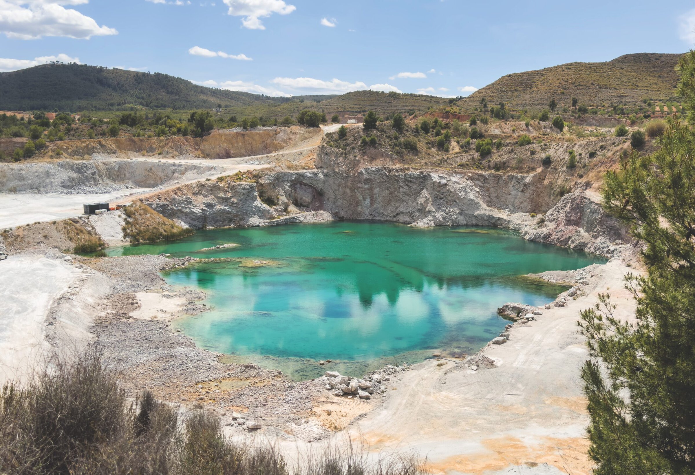 Open pit after lithium mining. Turquoise water in lake. Chalk and Dolomite development in quarry. Gypsum Mining and clay. Anthropogenic landscape in open cast mine. Limestone mining. Saint-gobain