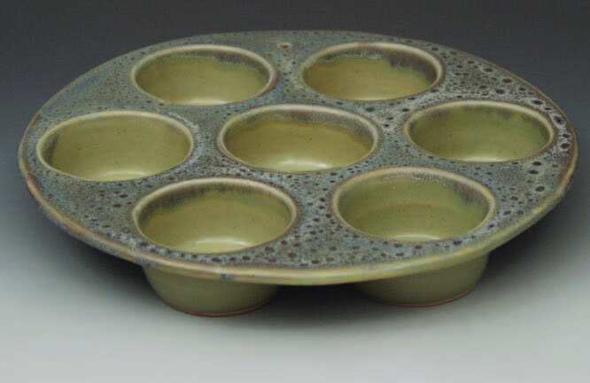 Colorful ceramic palette with multiple small bowls for mixing paints or glazes.