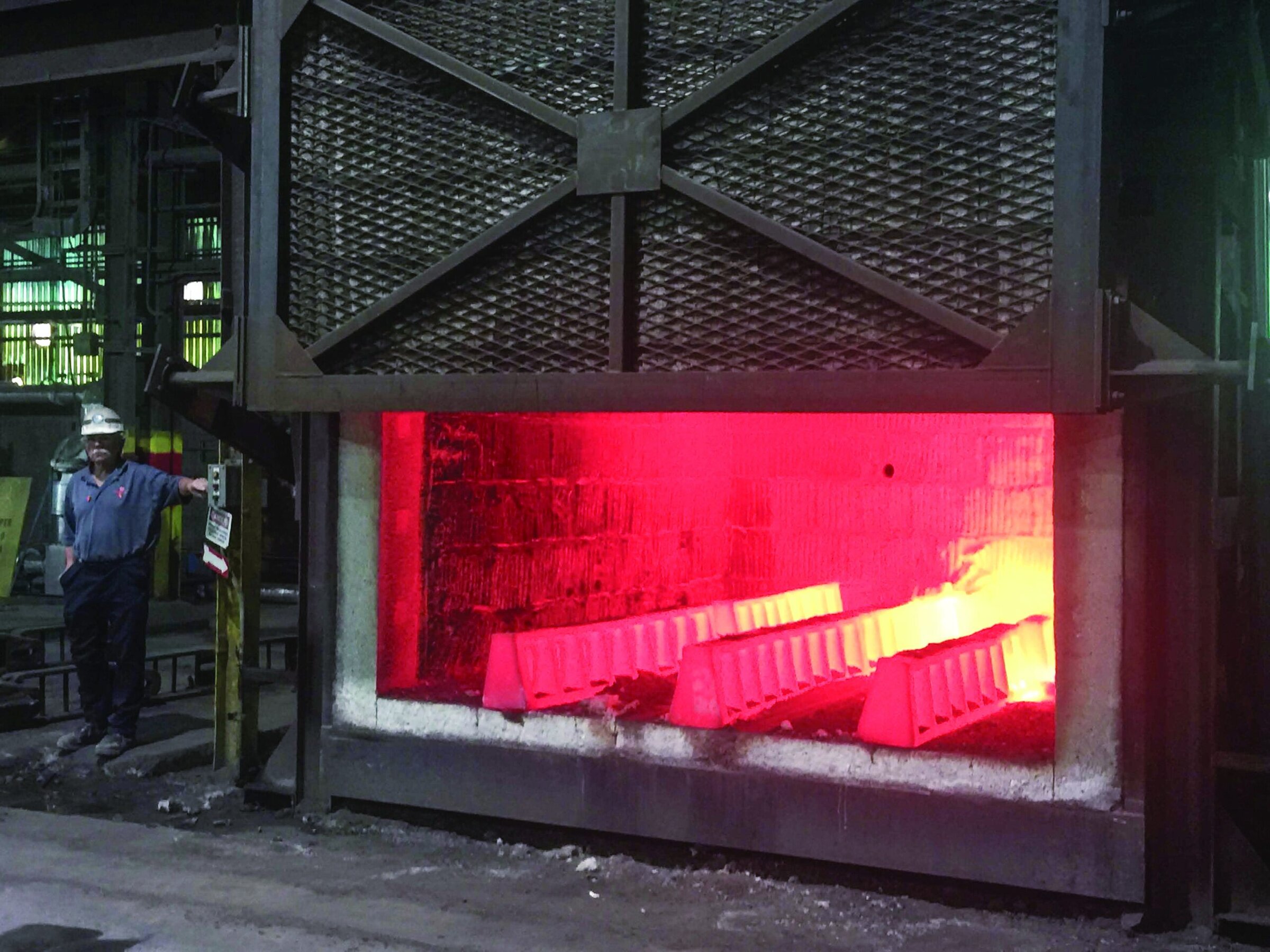 Molten ceramic material in industrial furnace showing glowing bright orange and red hues.