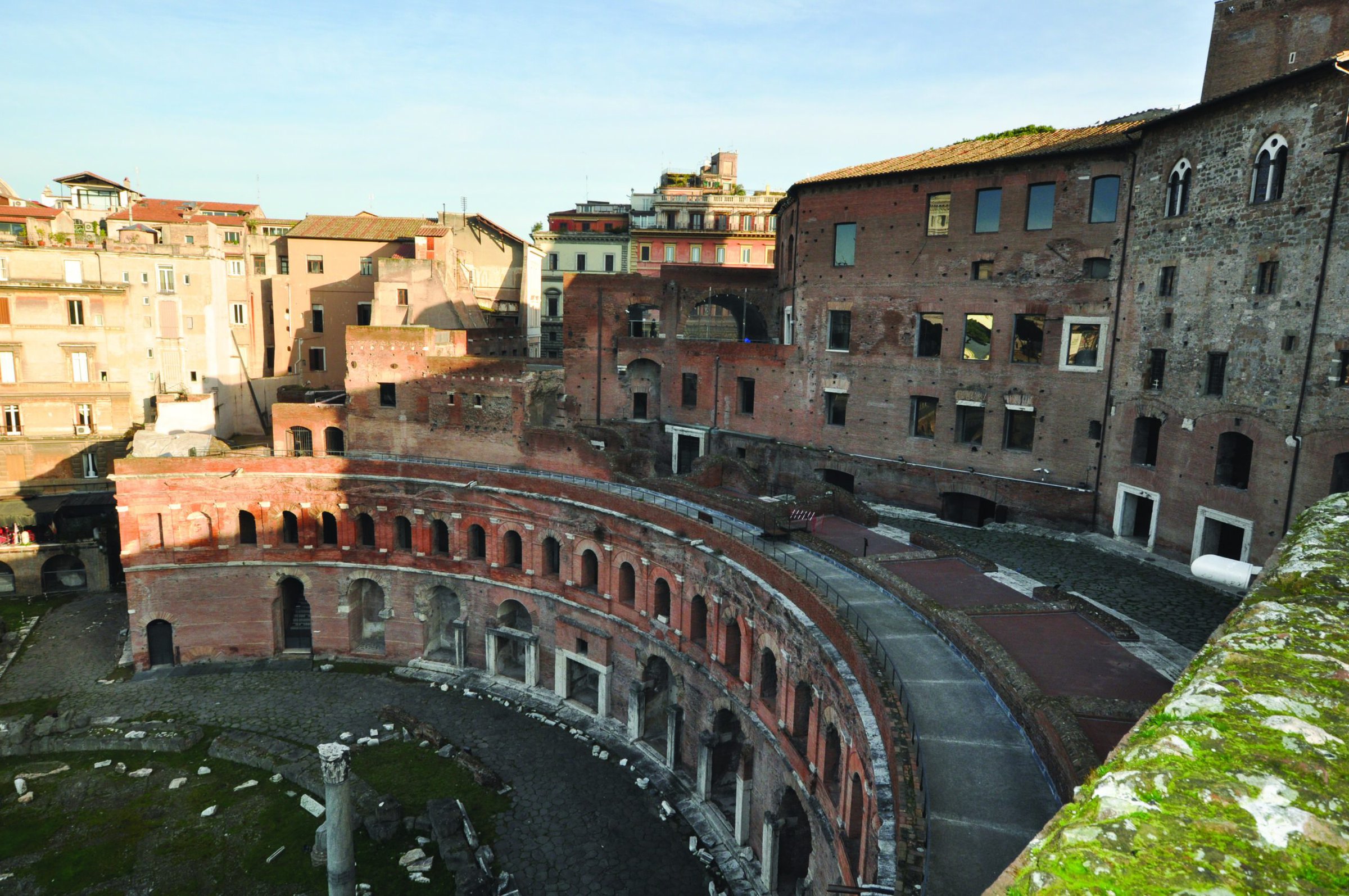 Ancient Roman amphitheater in Rome, with brickwork and historic architecture under a clear sky.