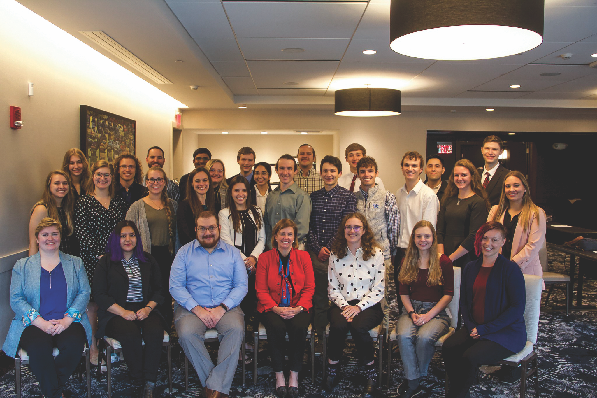 Group of PCSA students smiling for a photo in a conference room.