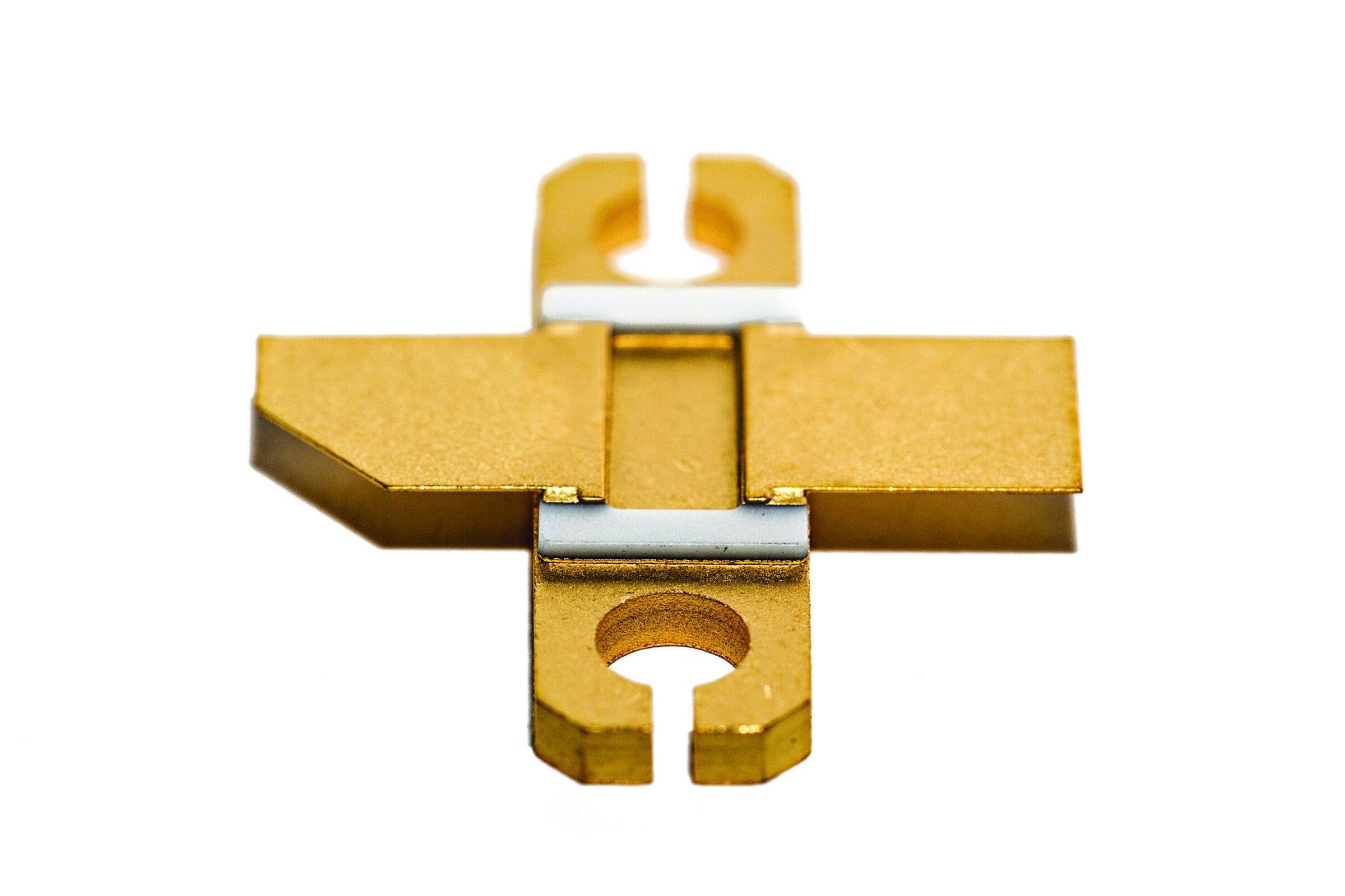 Gold ceramic component with intricate structural design for electronics or materials science applications.