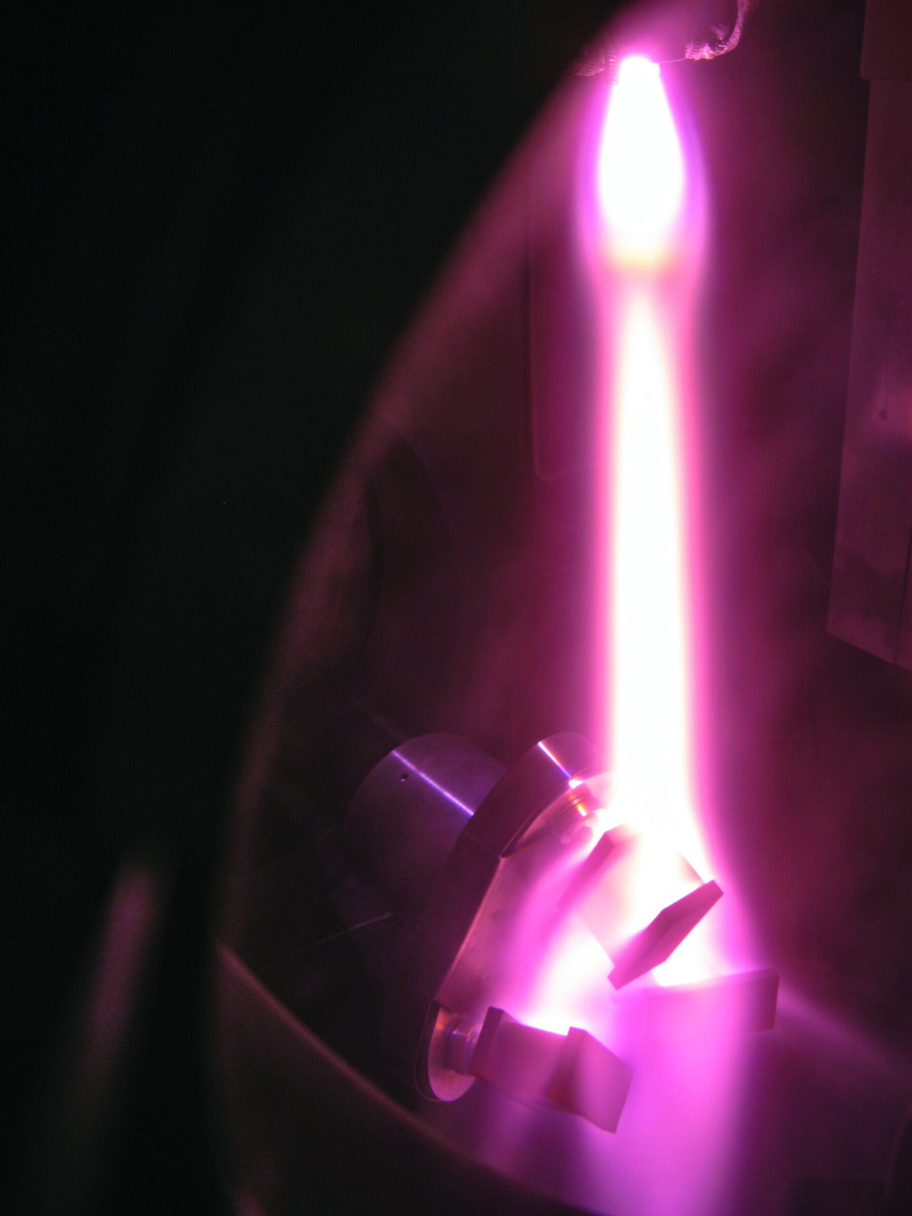 High-temperature ceramic firing process with vivid pink and purple plasma glow, showcasing advanced materials science in ceramics.