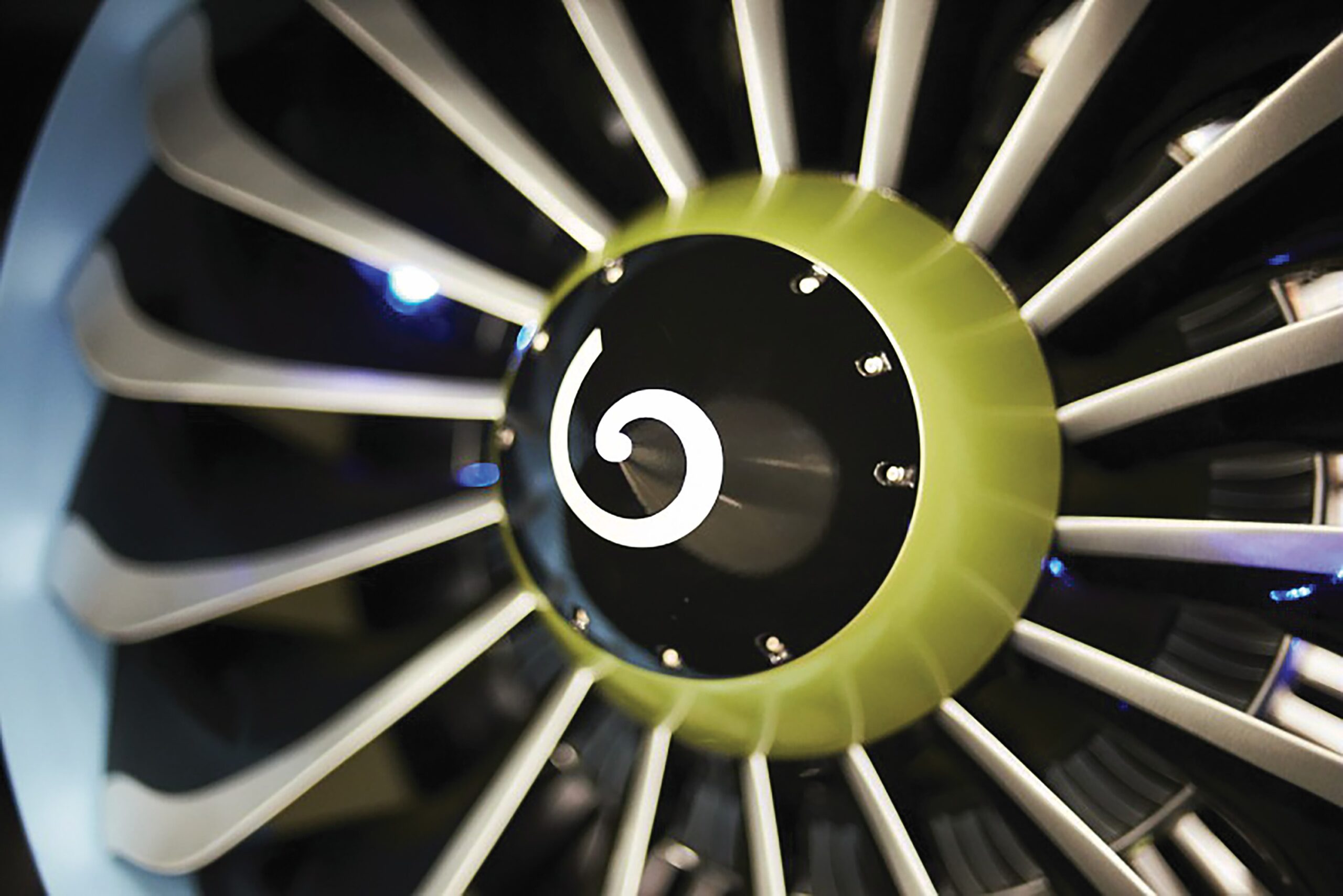High-tech turbine engine with metallic blades and green accents for advanced ceramics research.