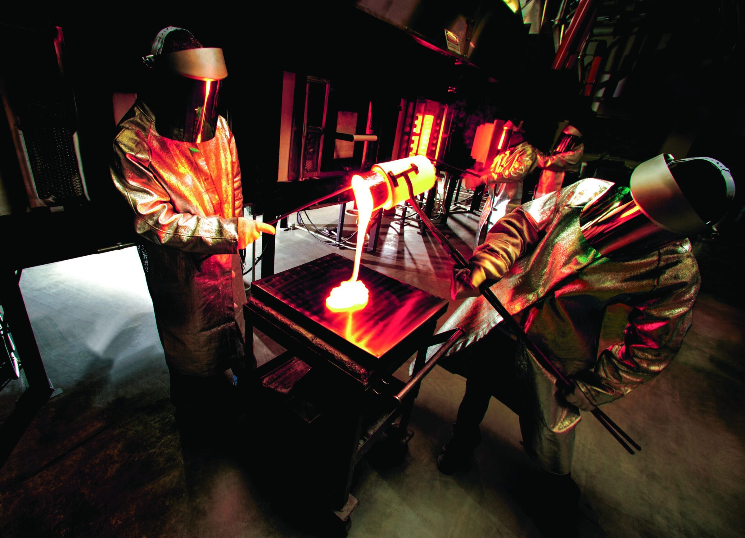 Molten glass being shaped with a blowpipe in a modern glass studio.