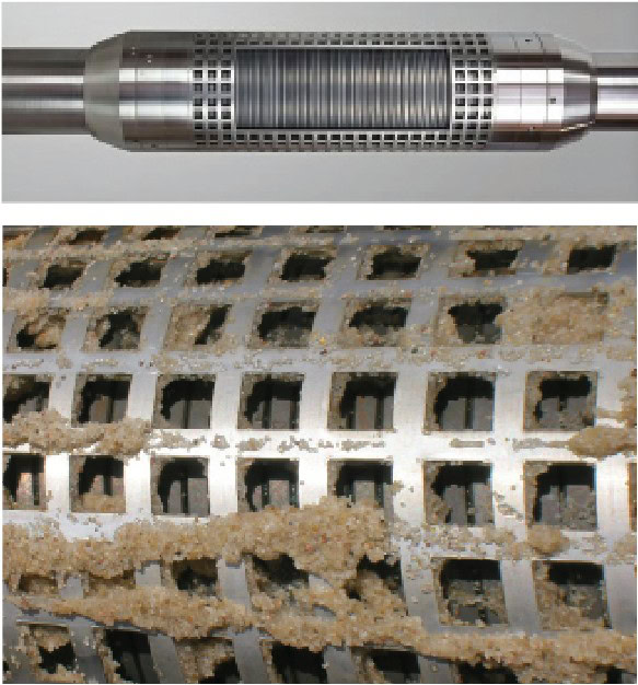 Close-up of a sand control screen, likely used in oil or gas wells, showing sand and debris buildup.