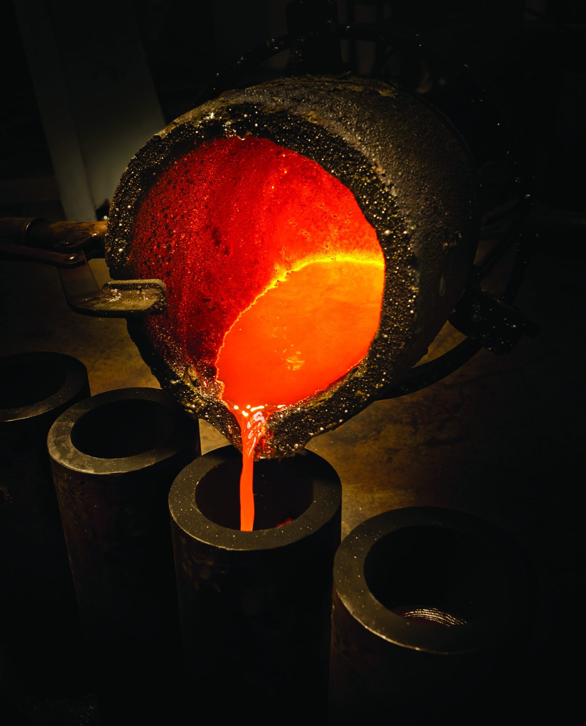 Molten ceramic material being poured into molds, showcasing advanced ceramics manufacturing.