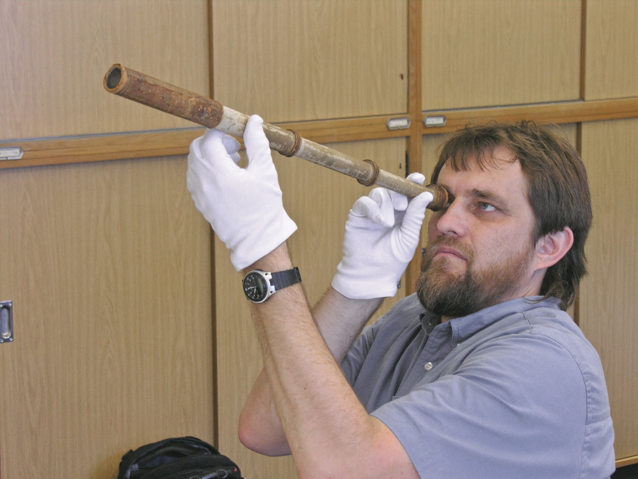 Ancient telescope research, scientist examining with telescope, ceramics, and materials, ceramic materials science, ACerS Bulletin.