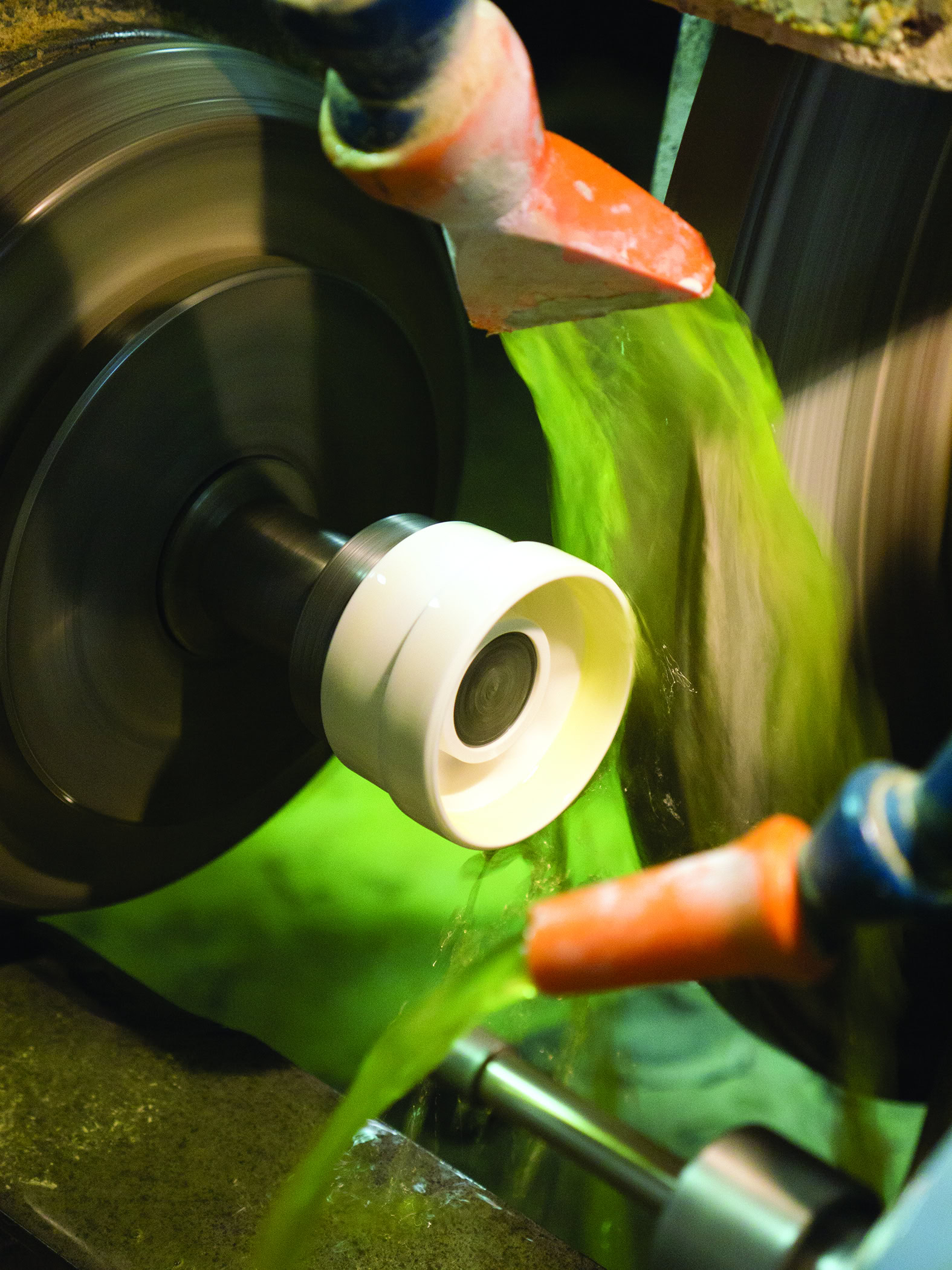 Shaping green ceramic slip on pottery wheel for kiln firing, highlighting ceramic arts craftsmanship.