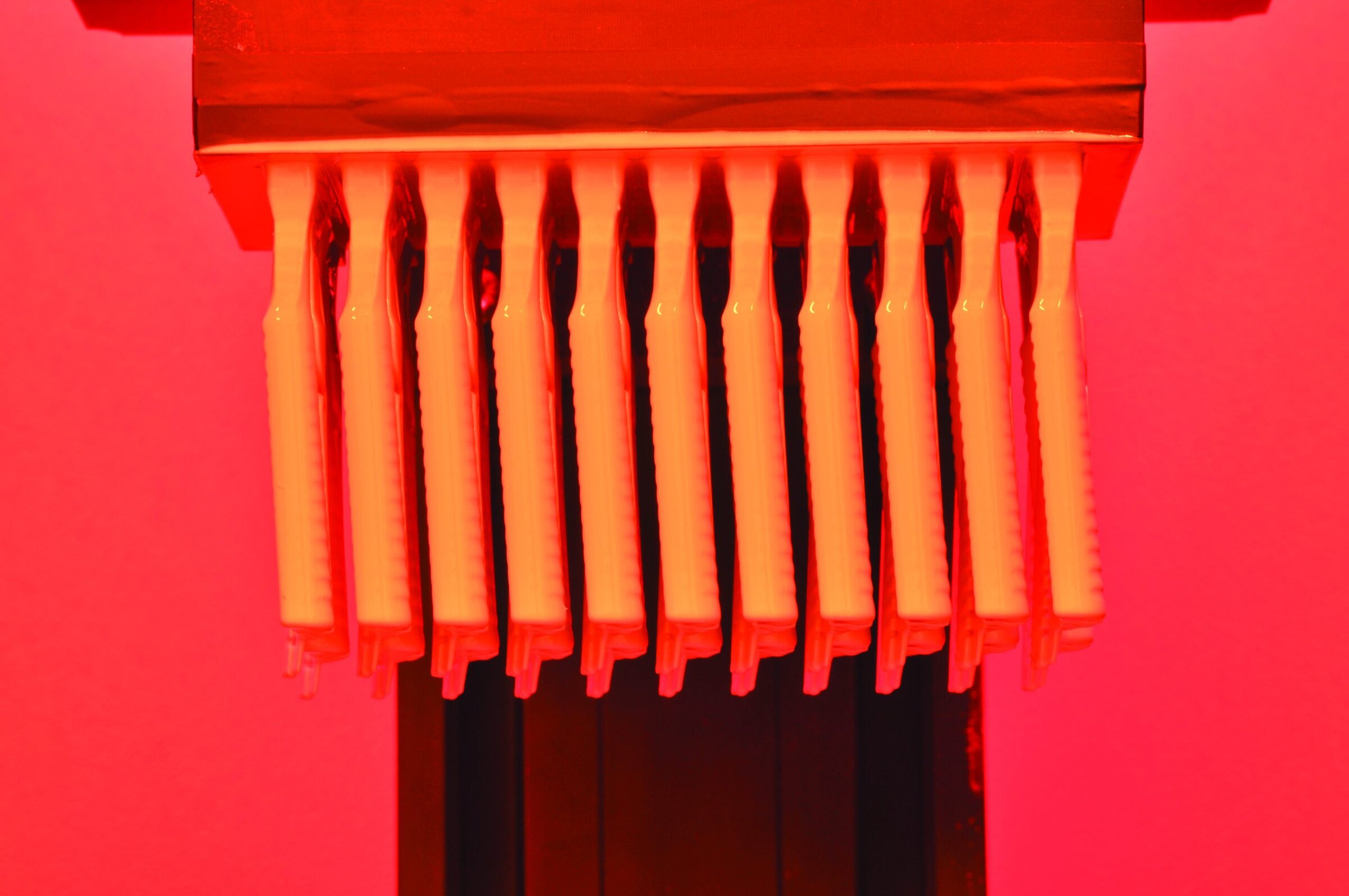 Vibrant ceramic sculpture with elongated orange hot neon lights, emphasizing ceramics art and innovation.