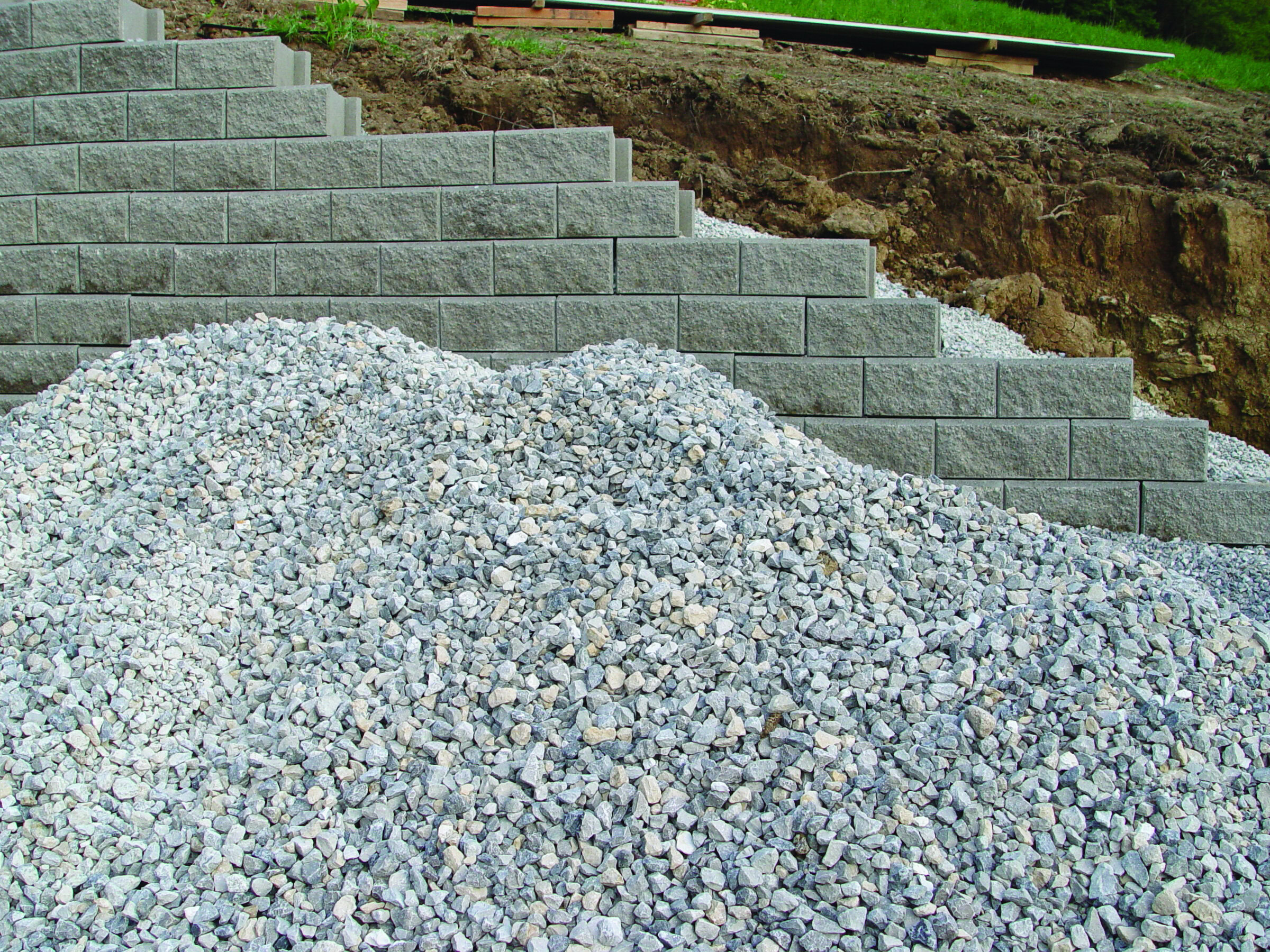 Stone retaining wall with gravel and concrete blocks reflecting ceramic and landscape design relevance.