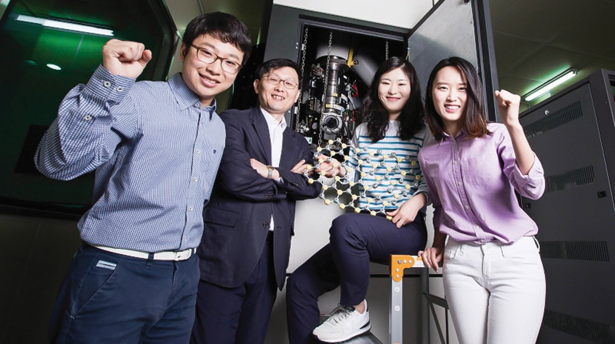 Diverse group of scientists celebrating in ceramics research lab, advanced materials and innovation focus.