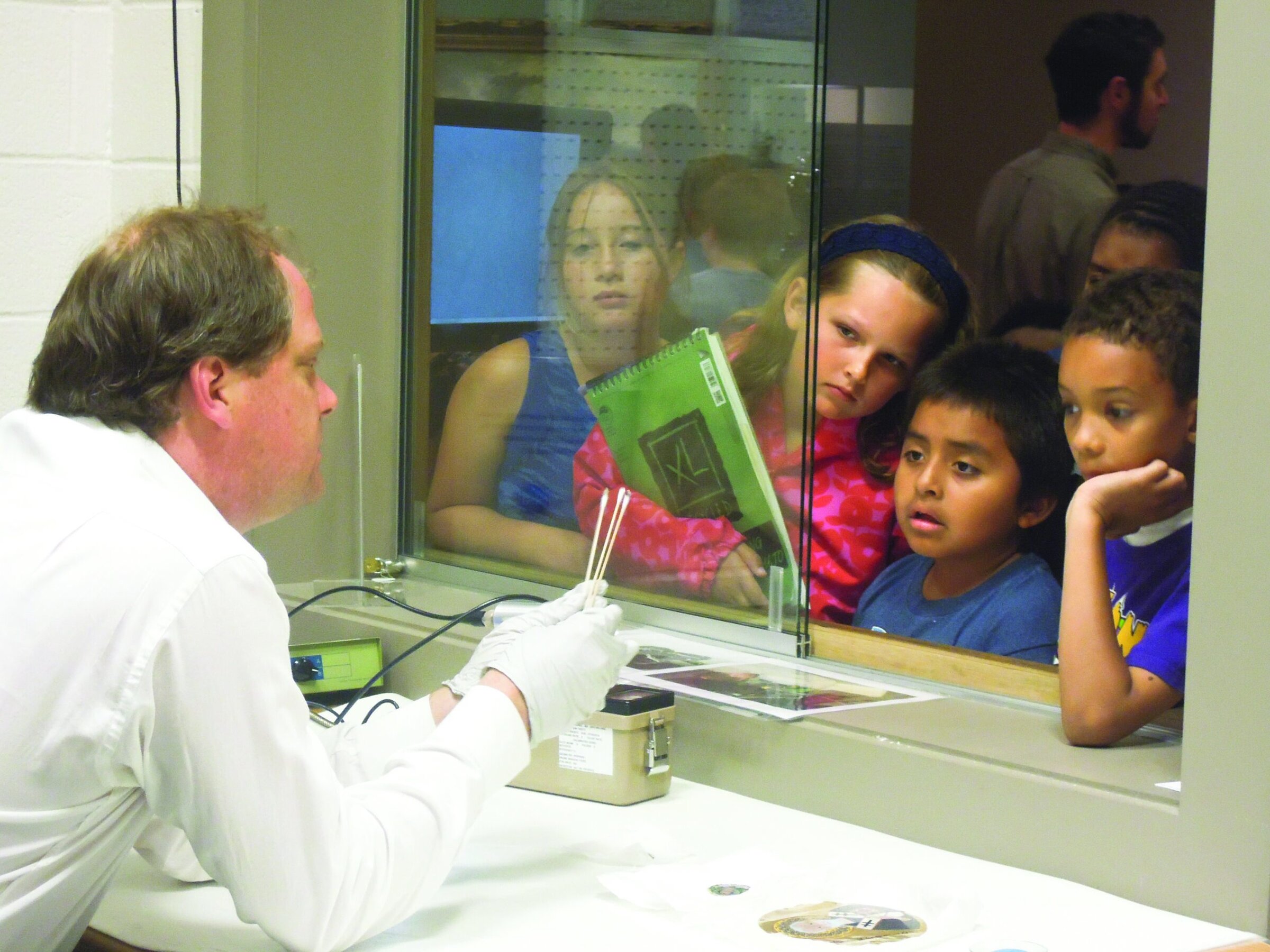 Student interaction with ceramic scientist at Ceramics Industry event, showcasing ceramic research and innovation.