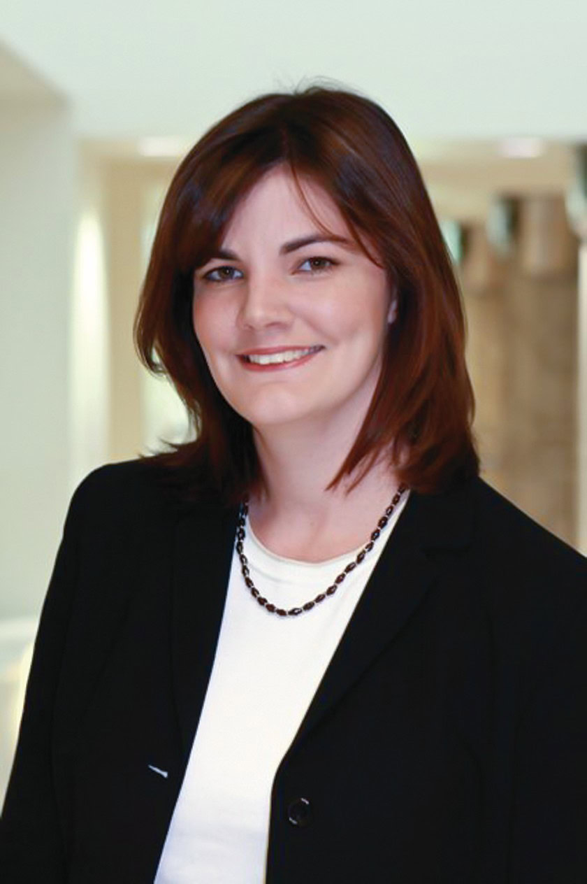 Woman smiling in professional attire for Ceramics Industry publication.