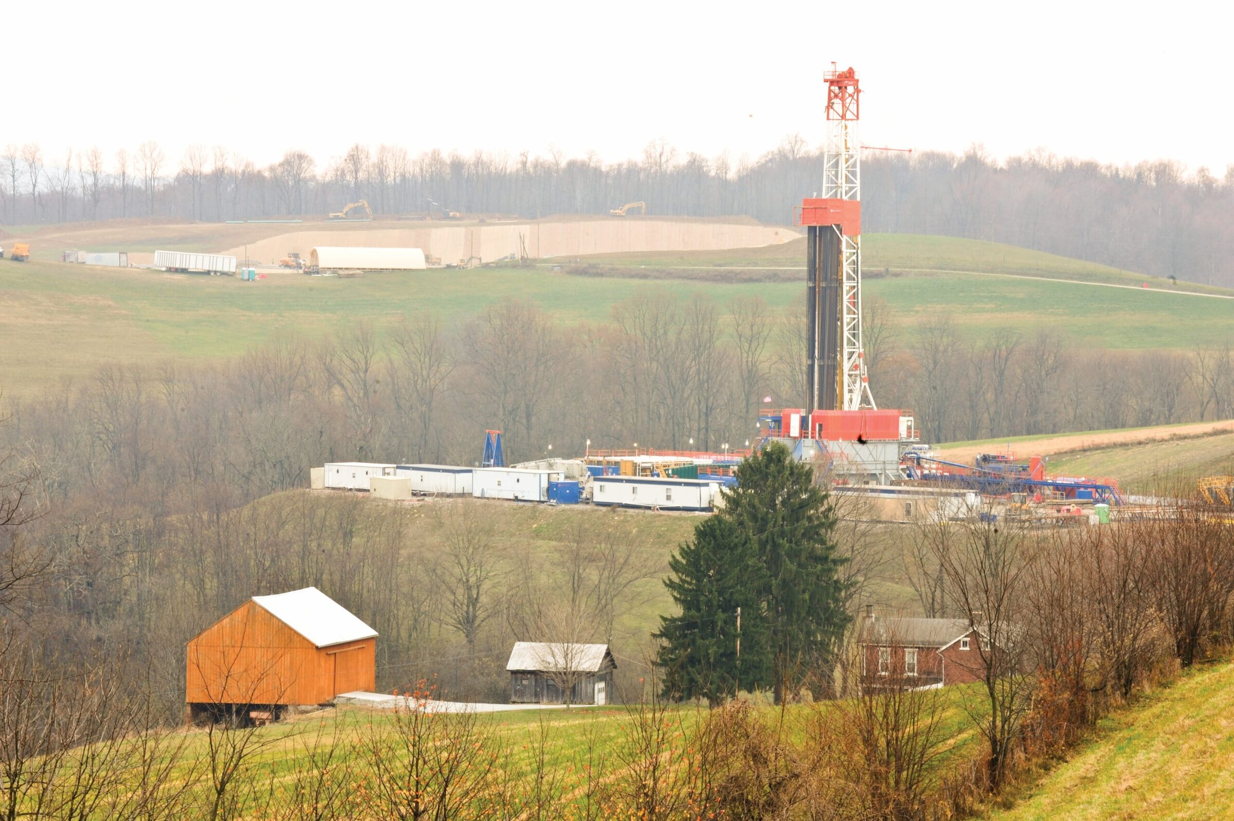 Heavy drilling rig on a green hillside for ceramics and materials testing.