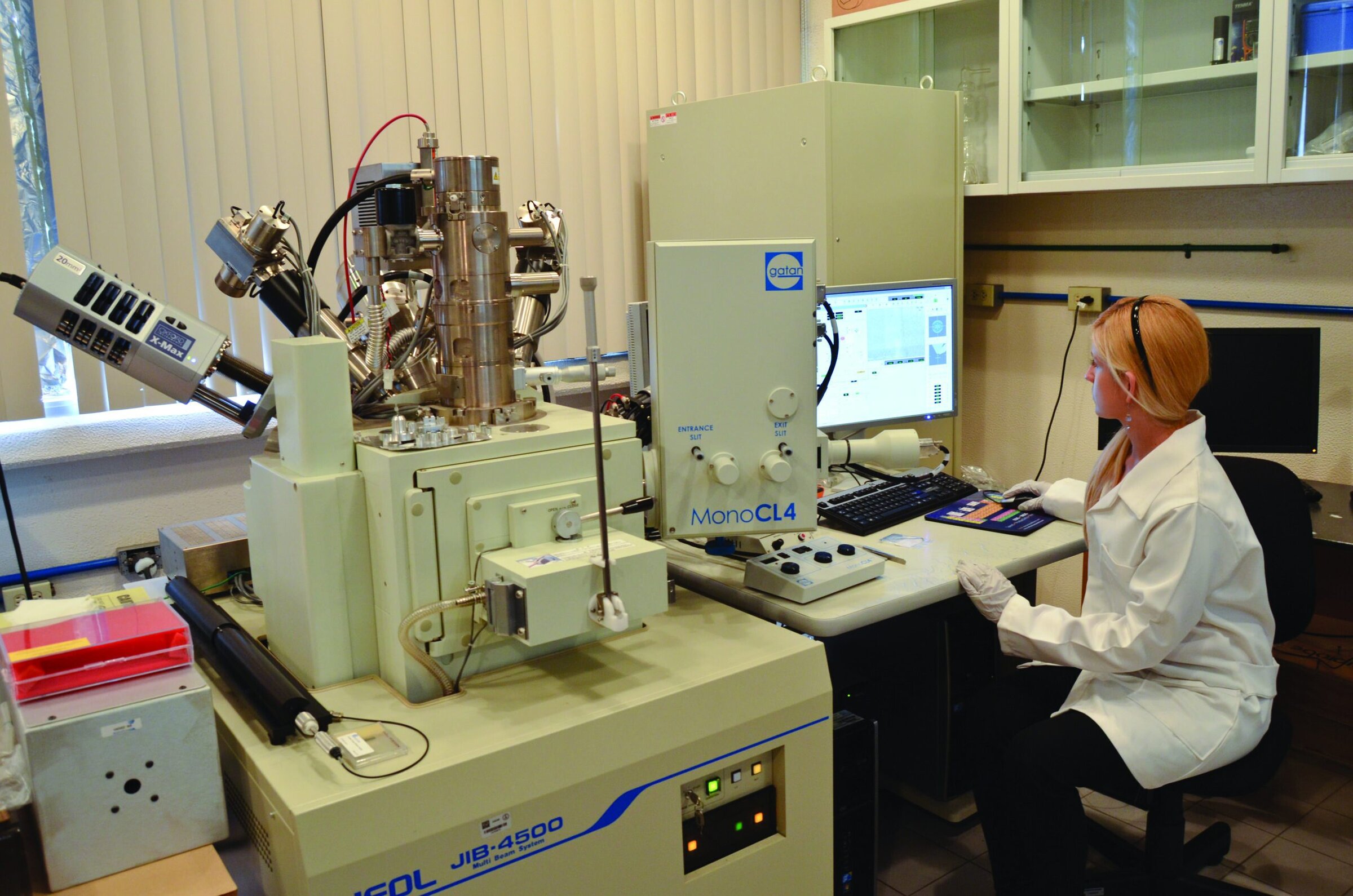 High-tech materials research laboratory with a scientist operating advanced scientific instrumentation for ceramic analysis.
