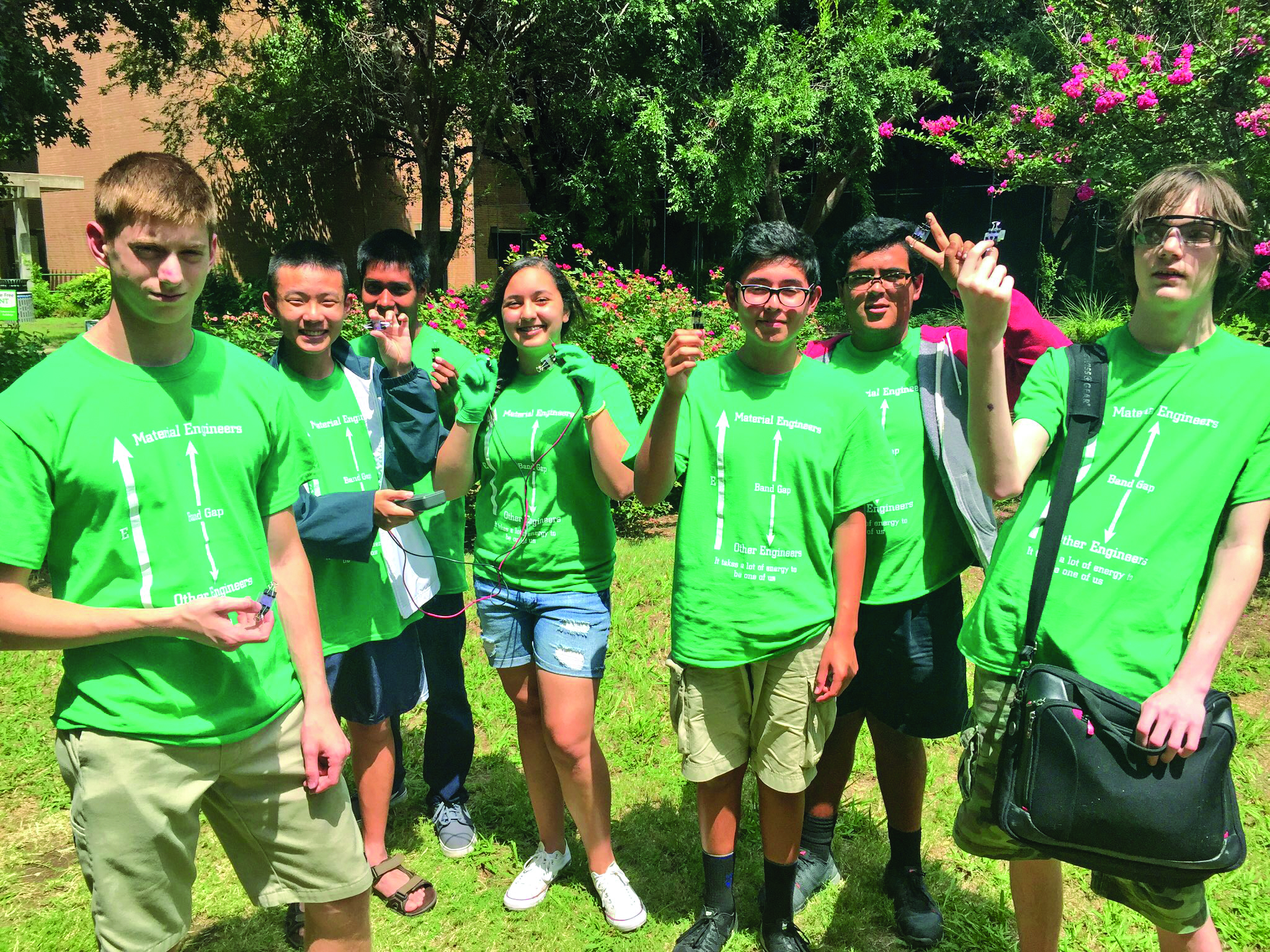Students in green shirts at a science summer camp.