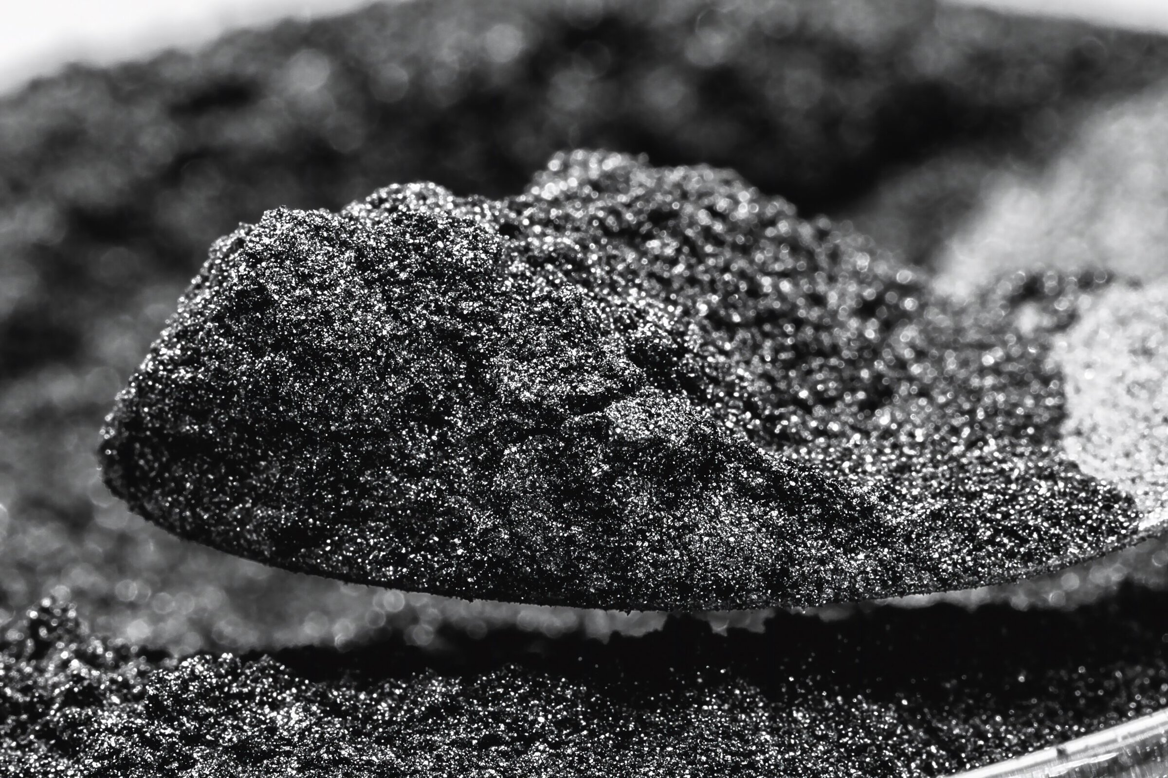 Close-up of a textured black ceramic or mineral sample with a rough surface.