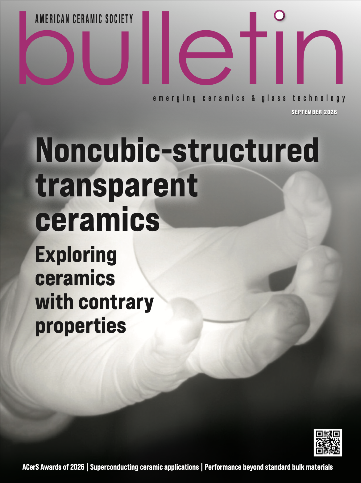 Close-up of a gloved hand holding a transparent ceramic sample, on the cover of the September 2023 ACerS Bulletin.